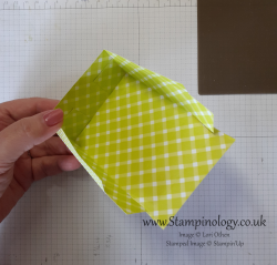 The previous mentioned lime green and white plaid paper has three of it's sides glued together so you can see how the tabs fit to the inside of the lid.